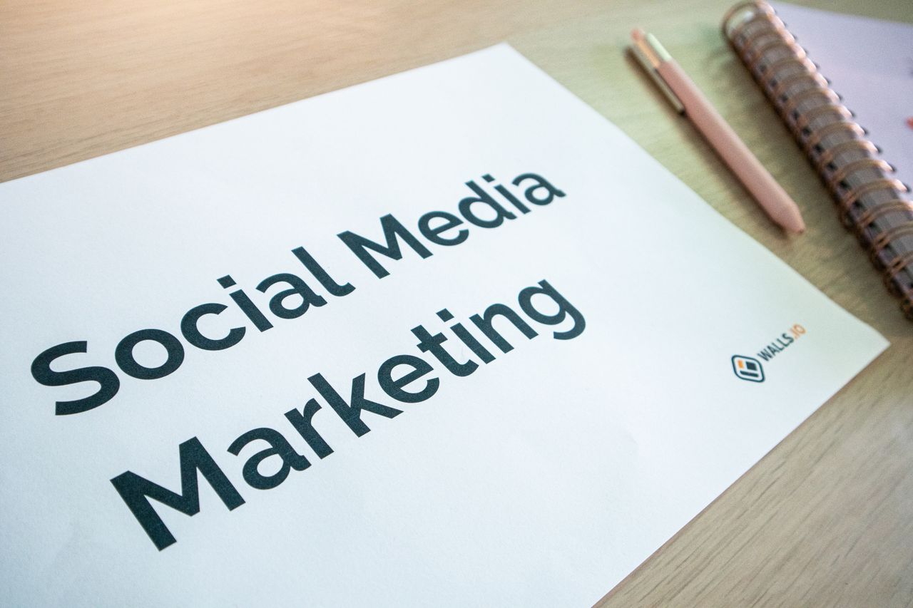 project-02-a Close-up of a social media marketing document on a desk with a pen and notebook.
